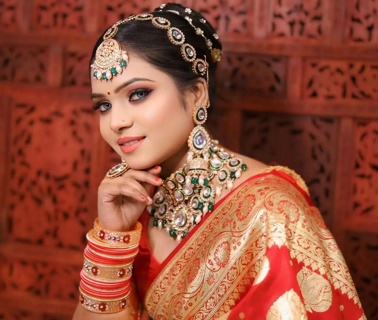 a woman in a red and gold sari